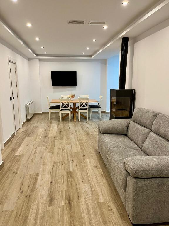 a living room with a couch and a table at Apartamentos HORNOS in Hornos