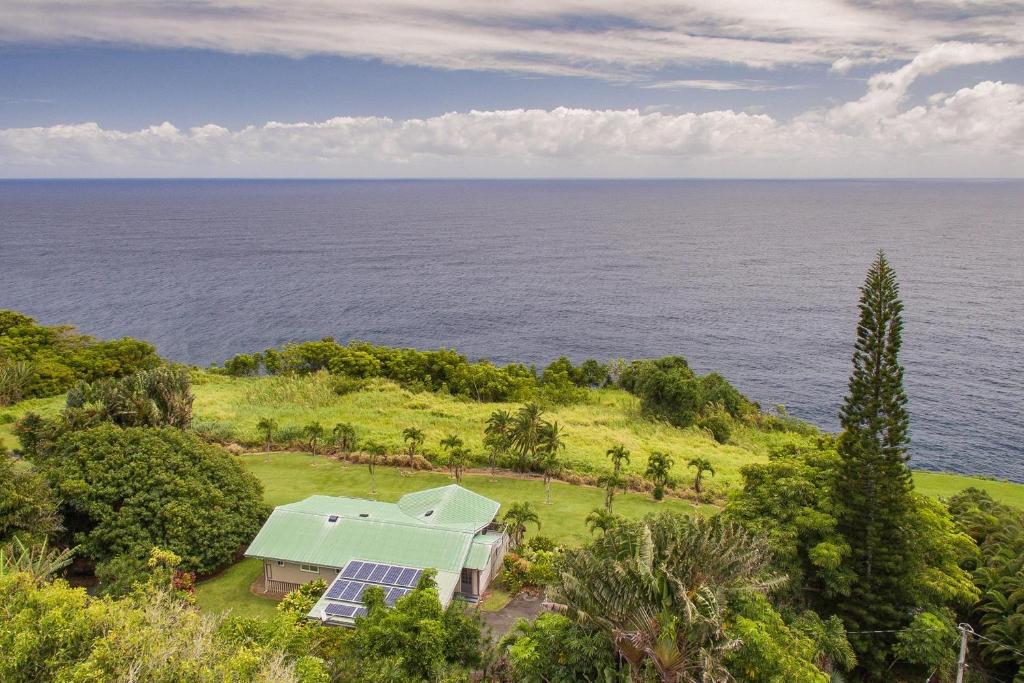 an aerial view of a house on a hill next to the ocean at Hale Hamakua in Papaaloa