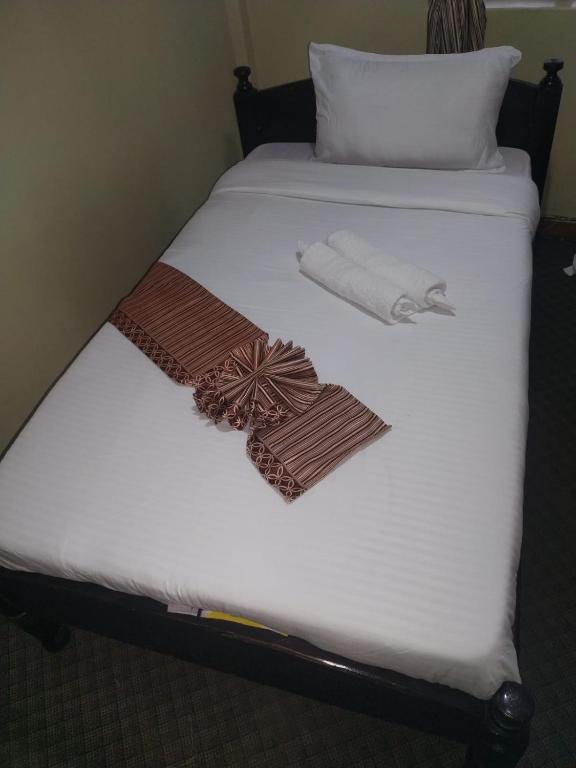 Postel nebo postele na pokoji v ubytování kapok city hotel