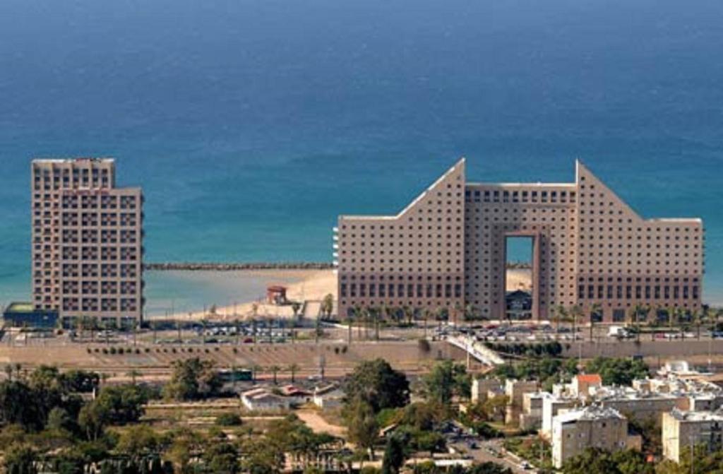 a city with two tall buildings and a bridge at Laguna Beach Apartments in Haifa
