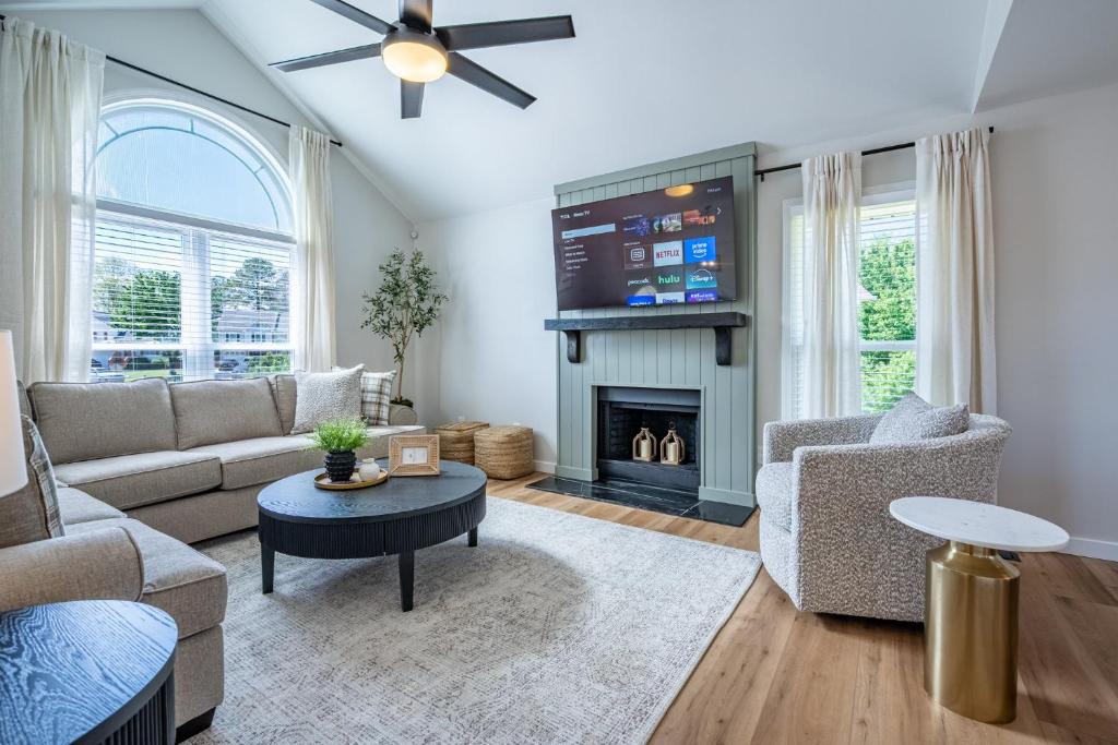 a living room with a couch and a fireplace at New Remodel! 4BR Near DT Cartersville & Major Hwys in Cartersville