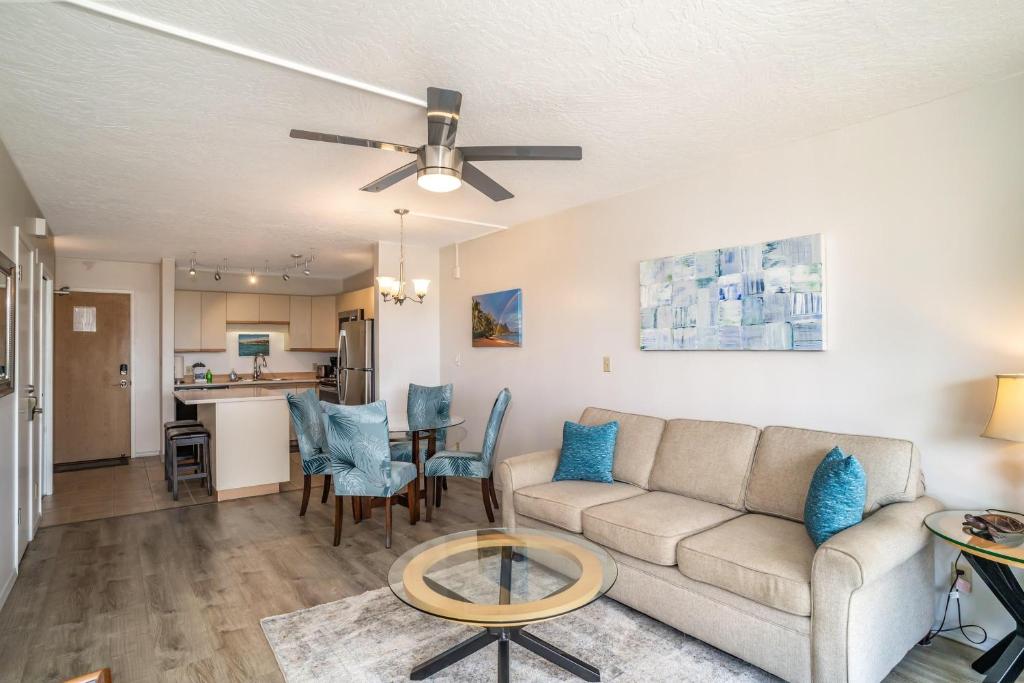 a living room with a couch and a table at Maui Banyan H506 in Wailea