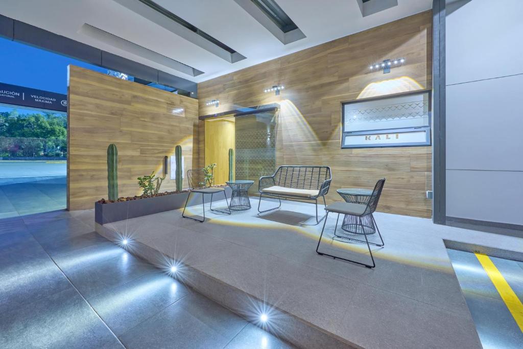 A compact reception lounge sits on a raised platform beside the hotel entry.