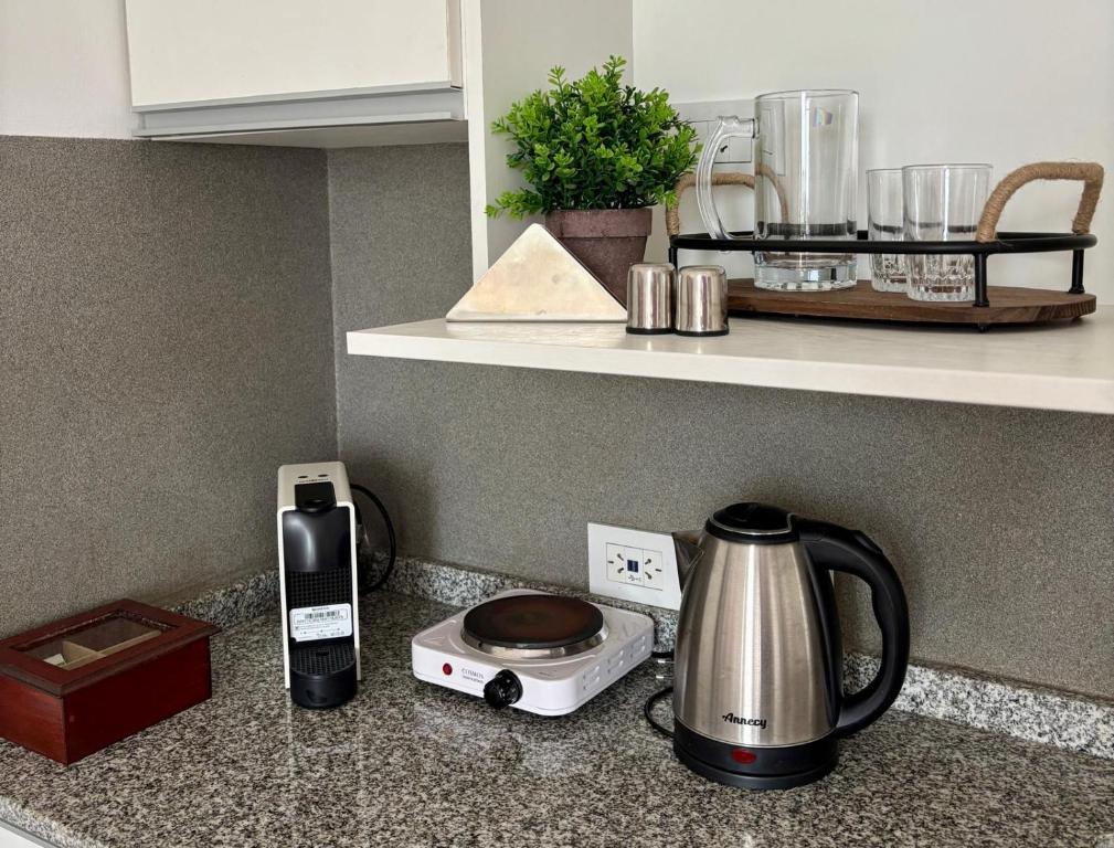 a kitchen counter with a coffee maker and a toaster at Studio for Tourism or Business Trip in Corrientes