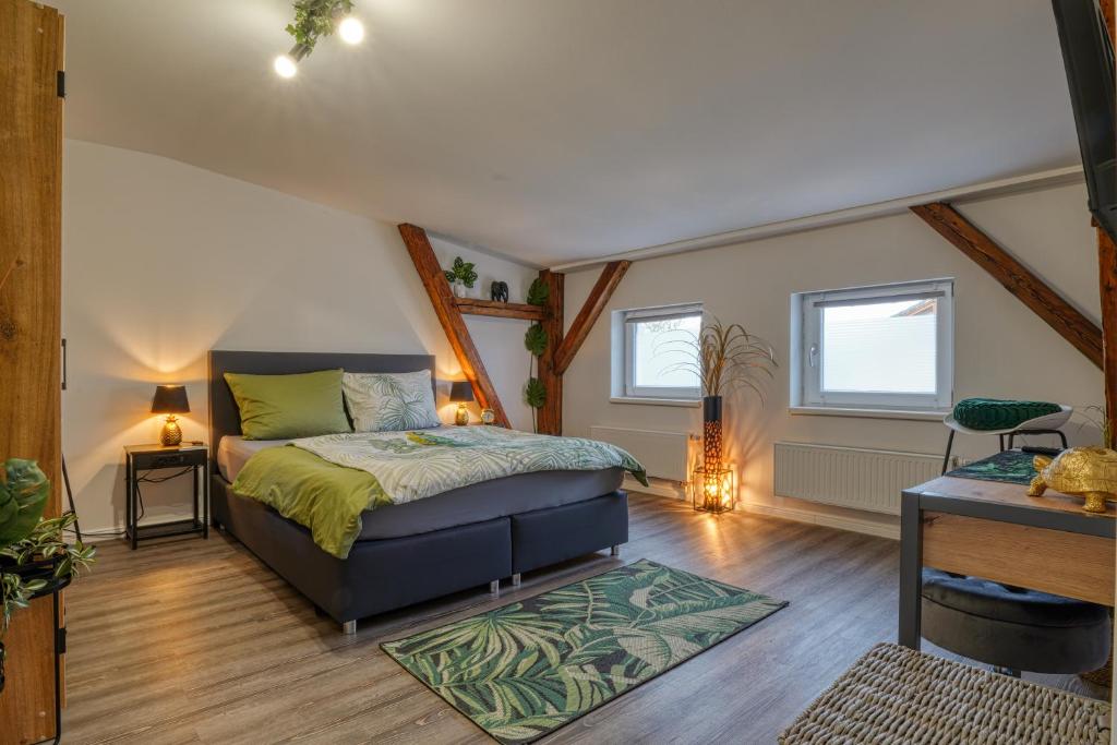 a bedroom with a bed in a attic at Zuarin Seeblick - Ganzes Apartment direkt am Schlossgarten von Schwerin mit Dschungelfeeling in Schwerin