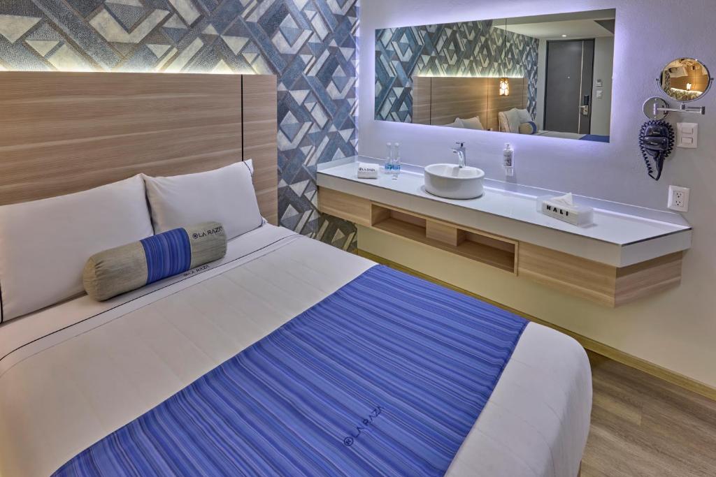 A bedroom with a large bed and an open vanity along the opposite wall.