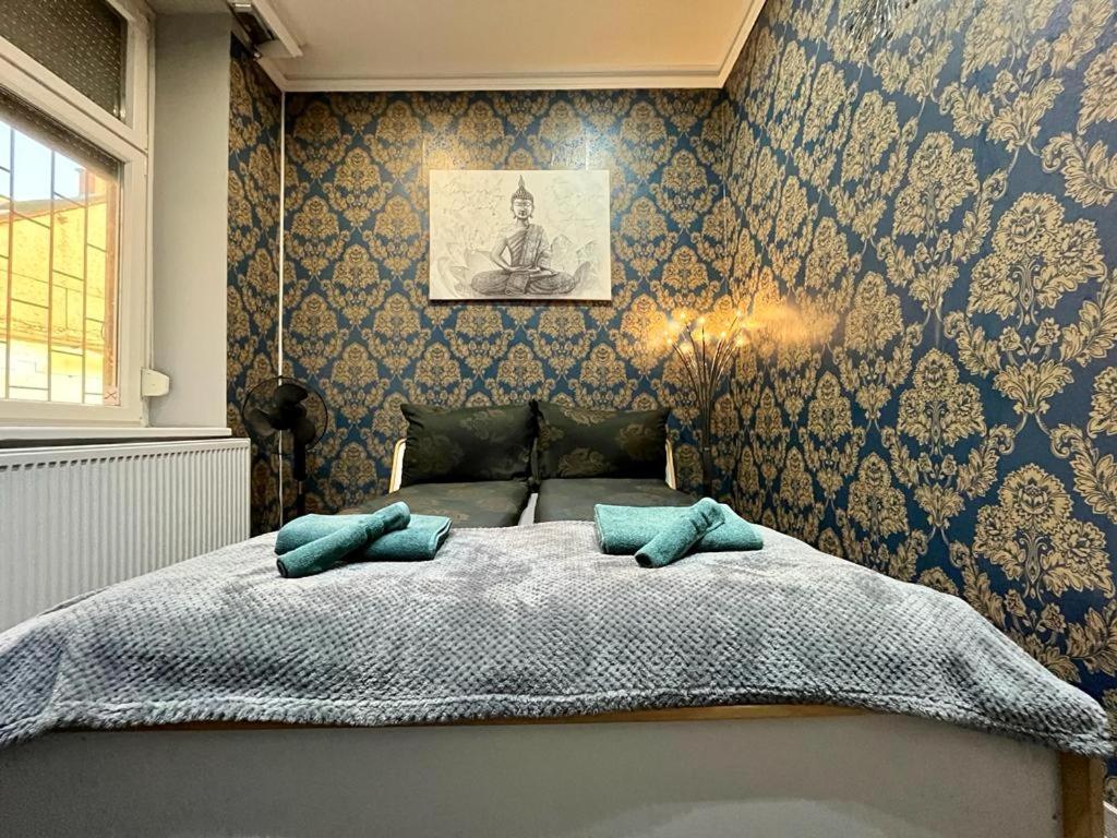 a bedroom with a bed with two pillows on it at JohnGold Buddha Room in Debrecen
