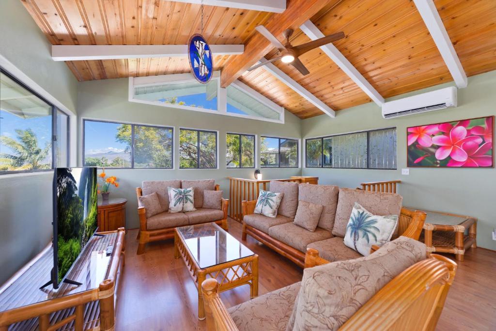 a living room with a couch and a tv at Pu'u Nui in Waikoloa Village