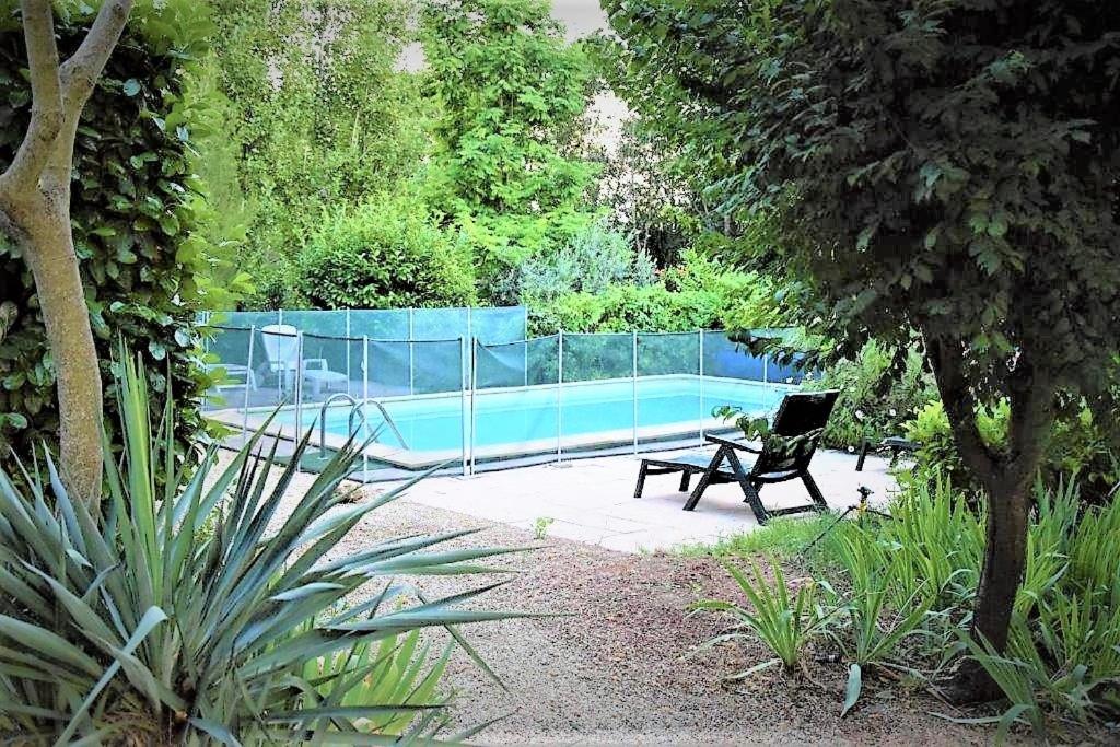 un banc installé à côté d'une piscine dans l'établissement La maison bleue, à Cadenet