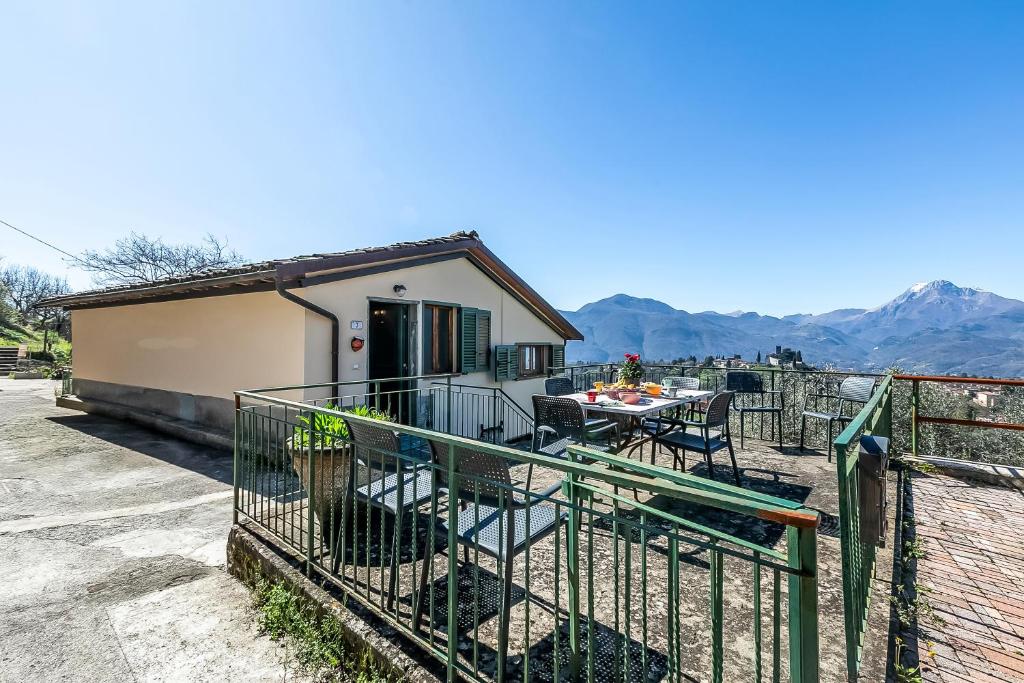 a house with a balcony with a table and chairs at Family Friendly Rosa House Amazing View - Happy Rentals in Barga