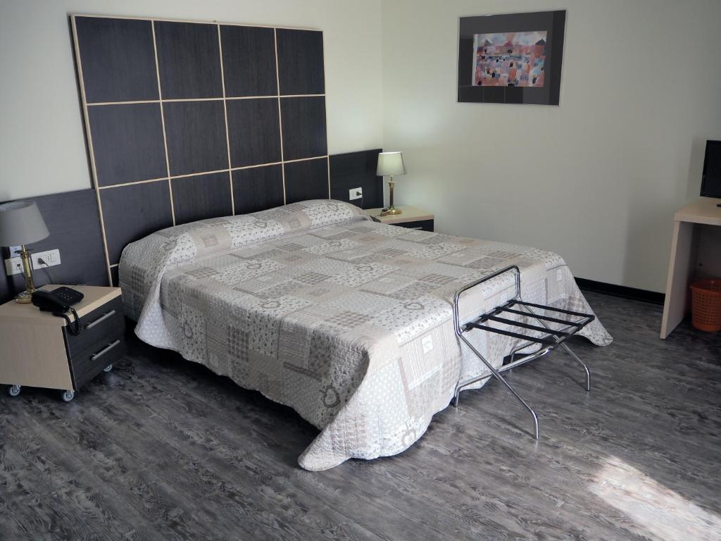 Postel nebo postele na pokoji v ubytování Hotel Ferrari