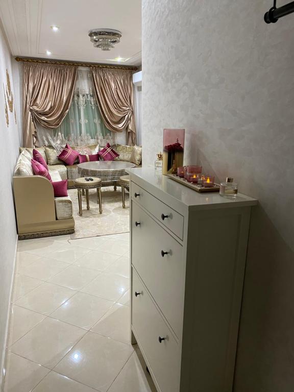 a kitchen with a table and a living room at Jnane meknes in Meknès