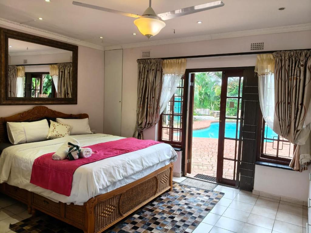 a bedroom with a large bed and a pool at Seaside sunny stay plus in Durban