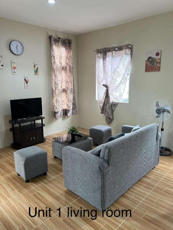 a living room with two couches and a tv at FHL transient house in Isulan