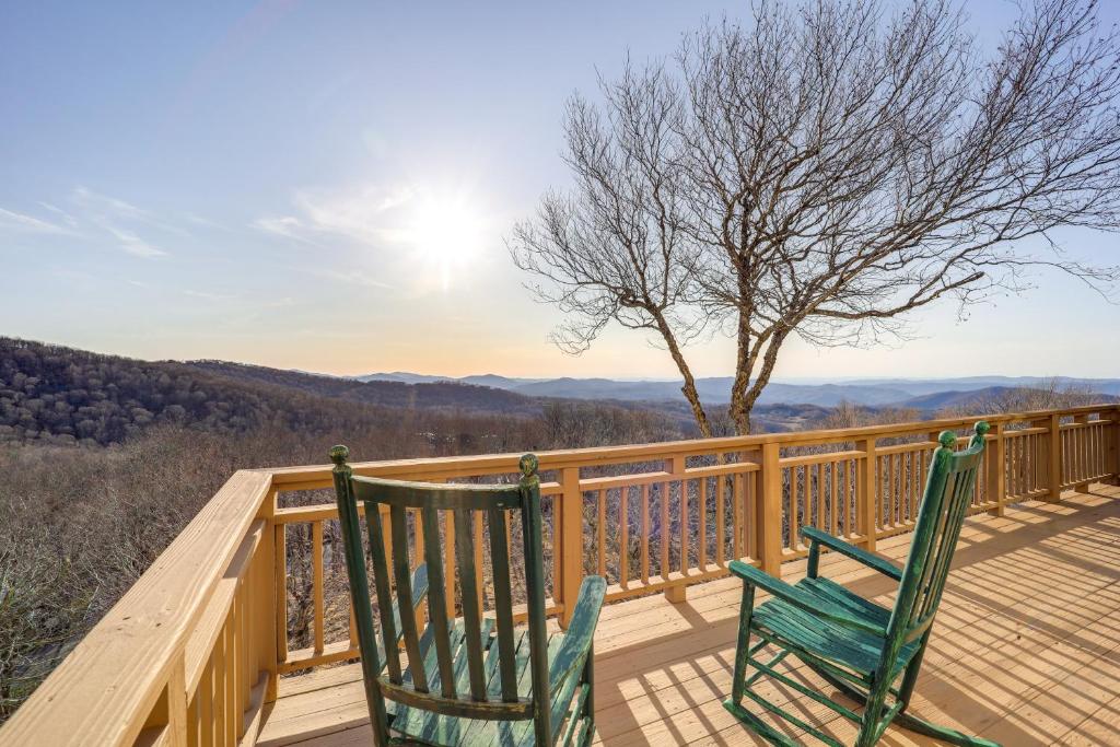 two green chairs sitting on a deck with the view at 3 Mi Beech Mtn Resort: Cozy Studio w/ Deck & View! in Beech Mountain