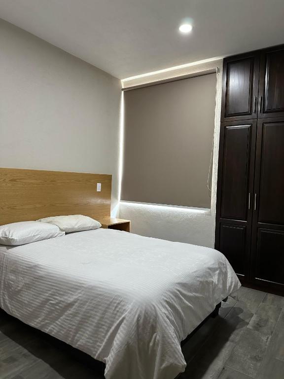 Postel nebo postele na pokoji v ubytování MR Hotel