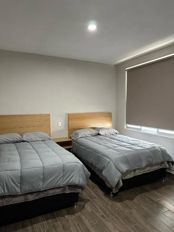 Postel nebo postele na pokoji v ubytování MR Hotel
