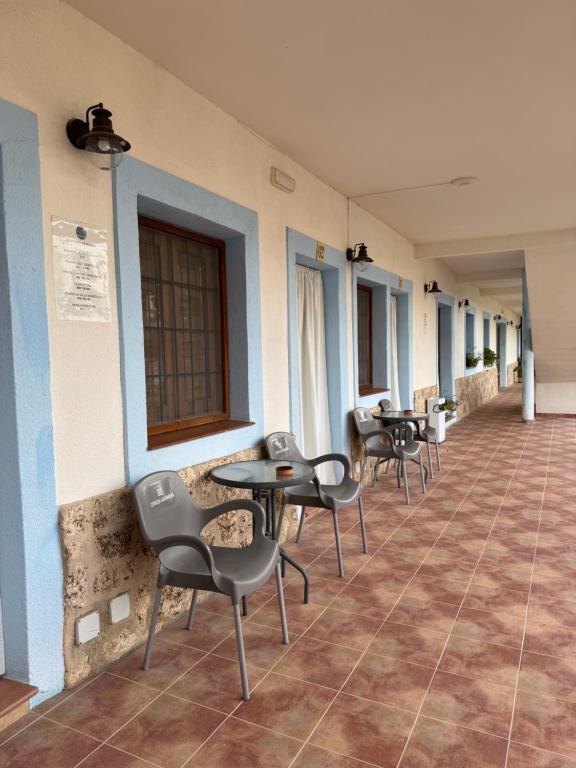 a row of chairs and tables in a building at Retiro Gastro-Rural - Habitaciones in Moratalla