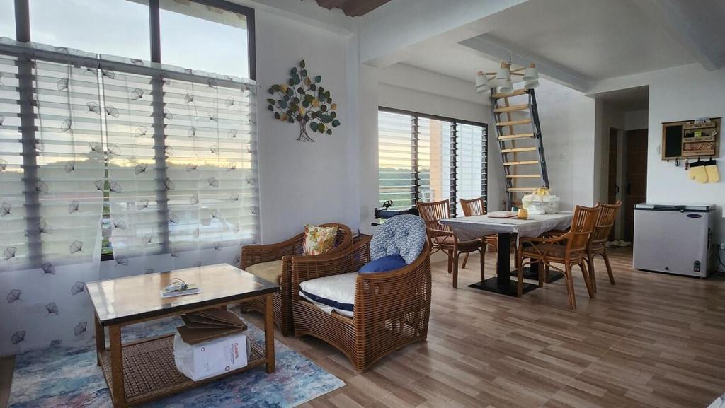 a living room with a table and chairs and a dining room at Inn the Mountain a farm house on a foggy farm hill in Cebu City