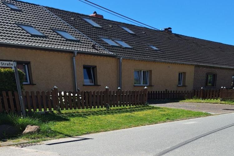 a house with a wooden fence in front of it at Peaceful Hideaway in Gorow in Gorow