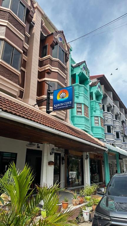 a building with a sign on top of it at Karon Cove at Seabreeze Inn in Karon Beach