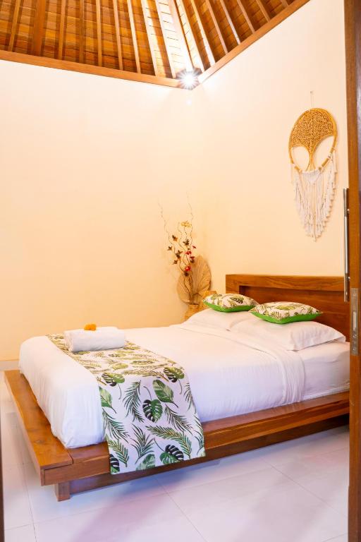 Postel nebo postele na pokoji v ubytování Cempaka Kembar Guest House