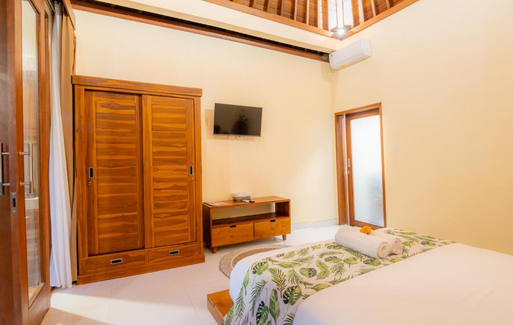 Postel nebo postele na pokoji v ubytování Cempaka Kembar Guest House