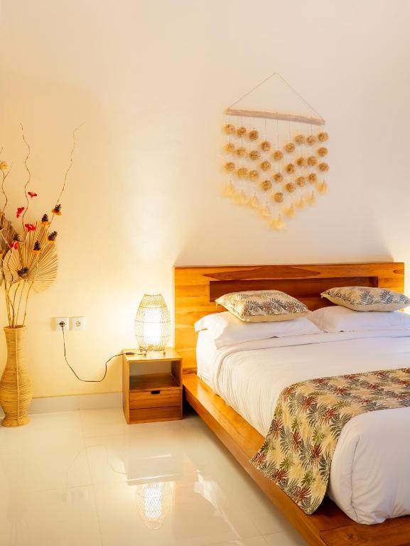 Postel nebo postele na pokoji v ubytování Cempaka Kembar Guest House