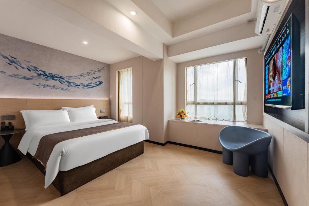 Voodi või voodid majutusasutuse Foshan Zhongying Holiday Hotel toas