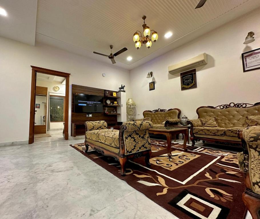 a large living room with couches and a table at Nova Villa with Patio Escape in Amritsar