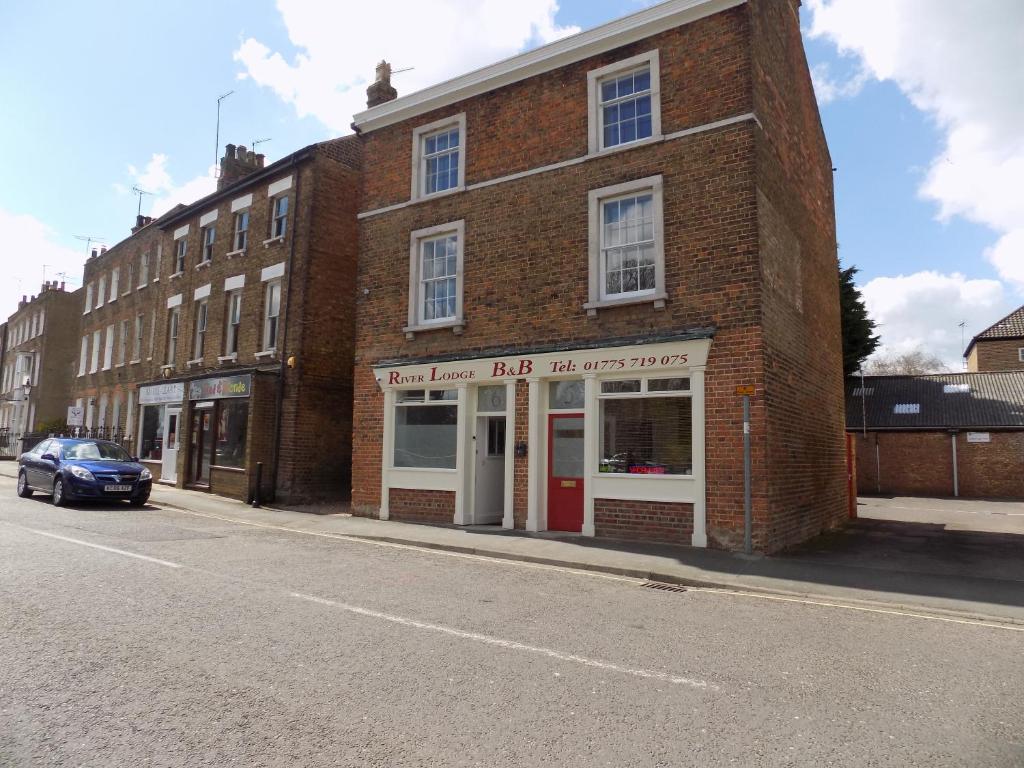 a brick building on the side of a street at River Lodge B&B Ltd in Spalding