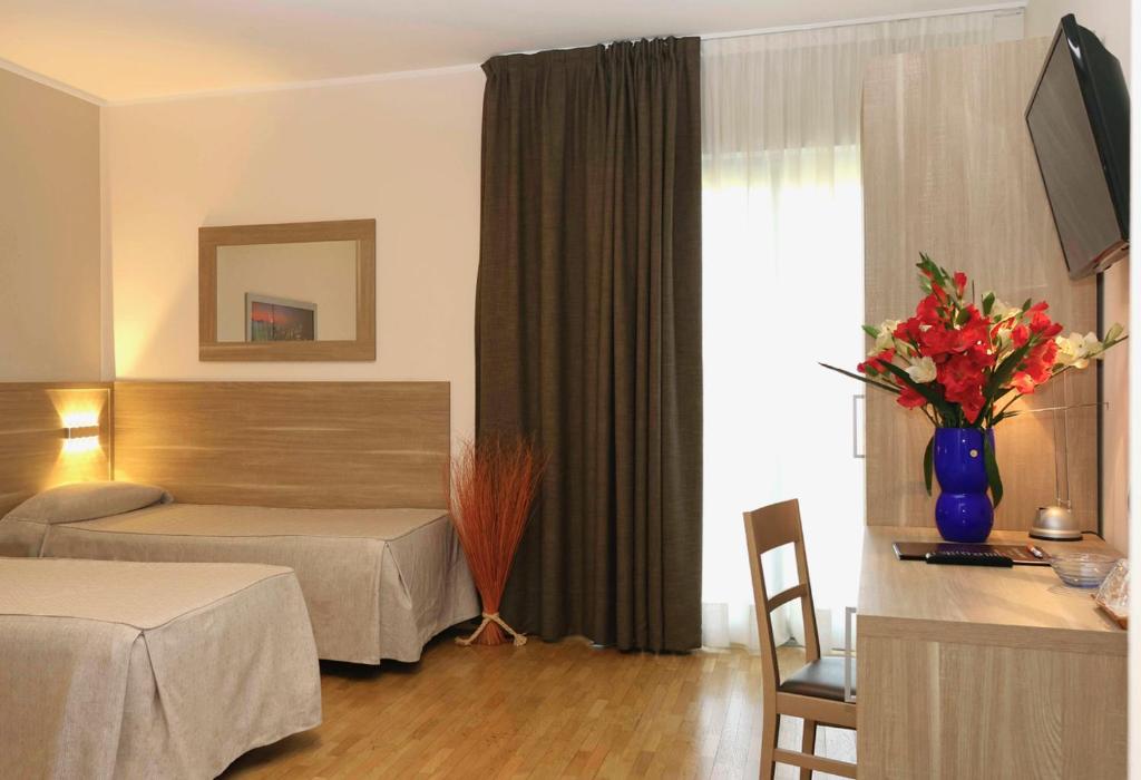 Postel nebo postele na pokoji v ubytování Dama Hotel