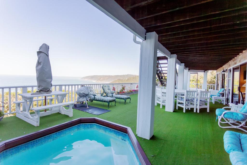 a house with a swimming pool on a balcony at Mi Vida - Wilderness in Wilderness