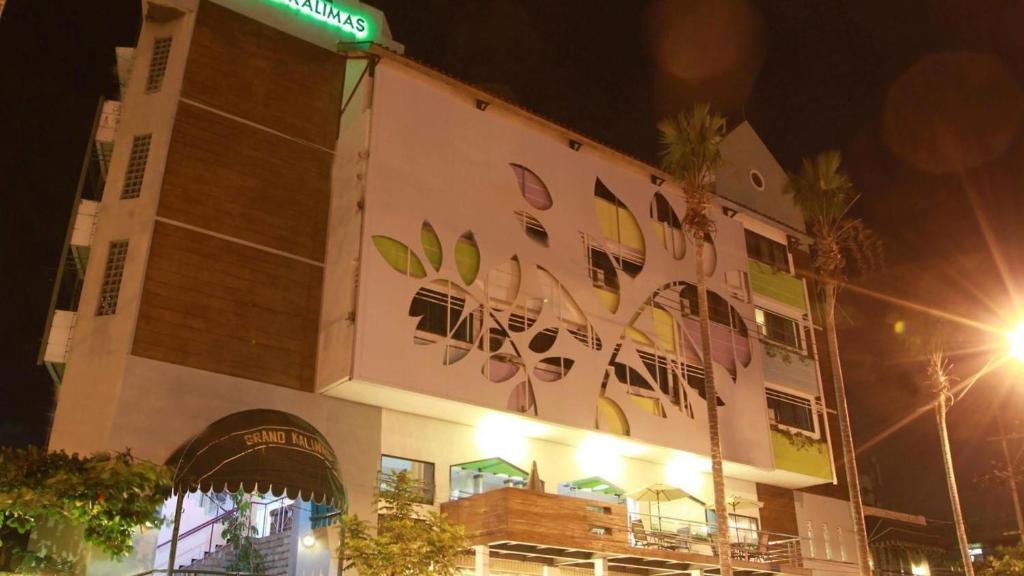 a building with a sign on the side of it at YUTAKA INN Kalimas Ampel Surabaya in Surabaya