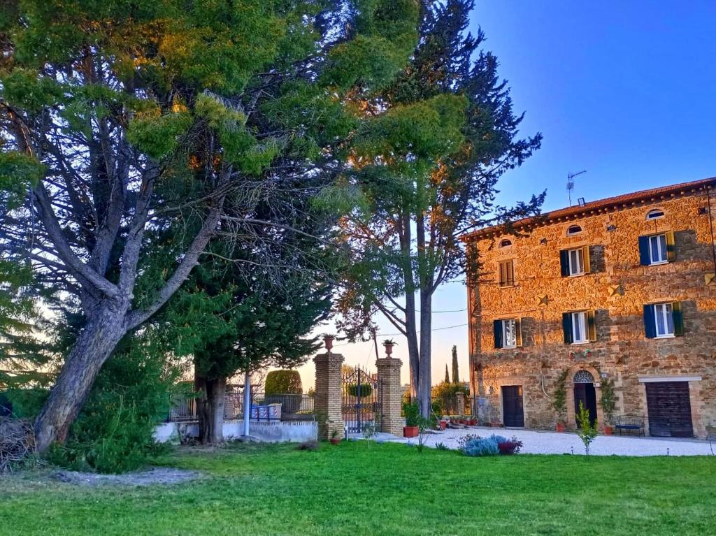 a large brick building with trees in front of it at La Casa del Belvedere in Perugia