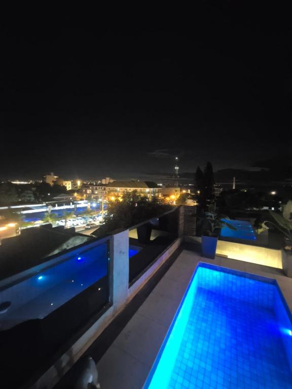 a swimming pool on the roof of a building at night at LOFT COSTANERA 200mts in Encarnación