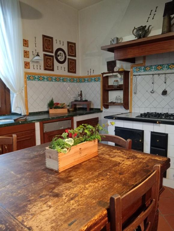 a kitchen with a wooden table with a crate of vegetables on it at Alina Villa with shared pool in Montecatini Terme