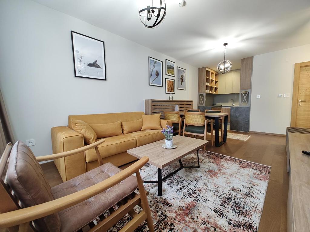 a living room with a couch and a table at Apartmani Trg Zlatibor in Zlatibor