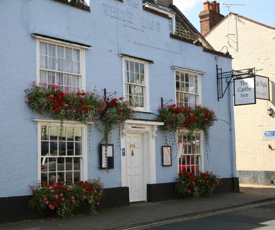 a blue building with flowers on the windows at The Castle Inn in Bungay