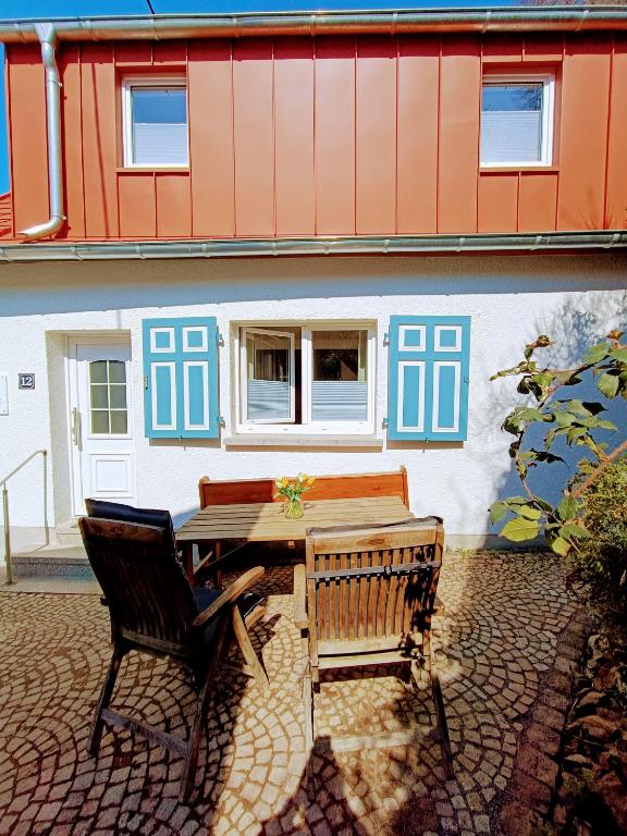 a table and two chairs in front of a building at Dein Eifelhaus in Langenfeld