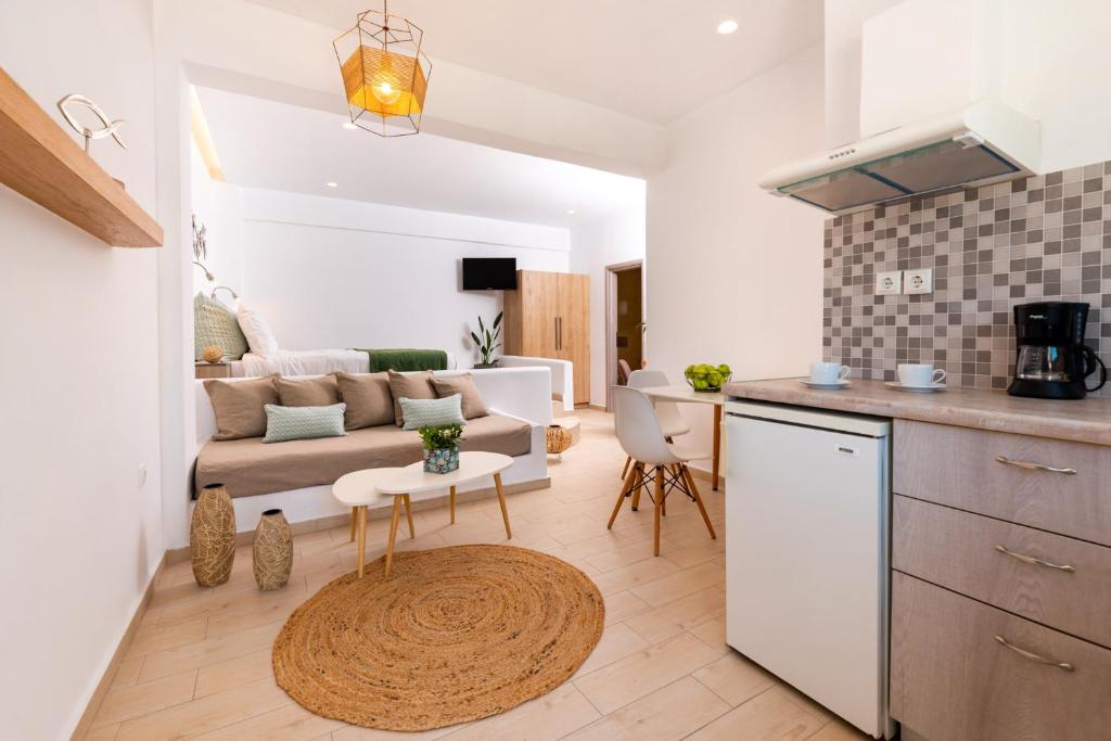 a kitchen and living room with a couch and a table at Evnia apartments in Vóthon