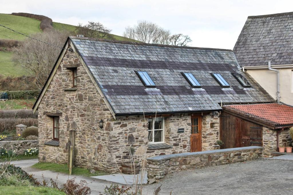 an old stone house with a slate roof at *New* Tranquil Countryside Luxury Barn Conversion in Georgeham