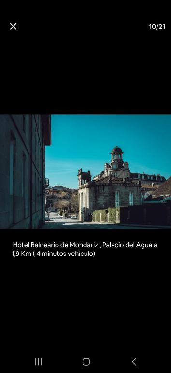 a view of a city with a building in the background at El pisito de iker in Mondariz