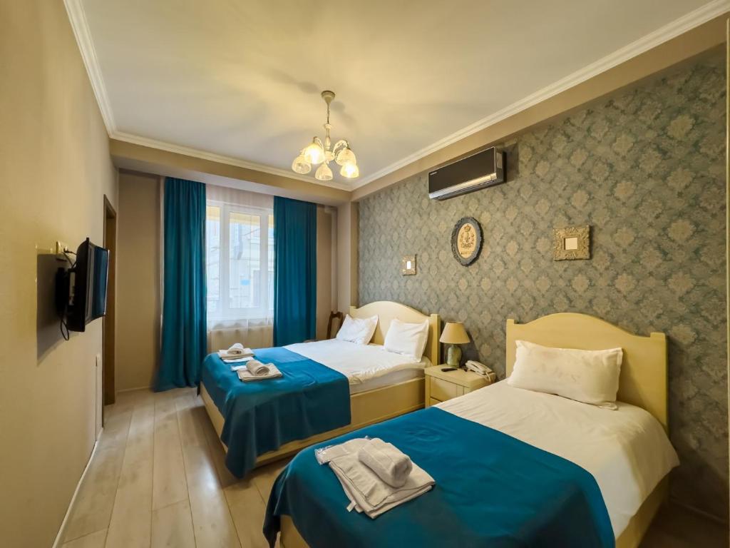 Postel nebo postele na pokoji v ubytování Hotel New Metekhi
