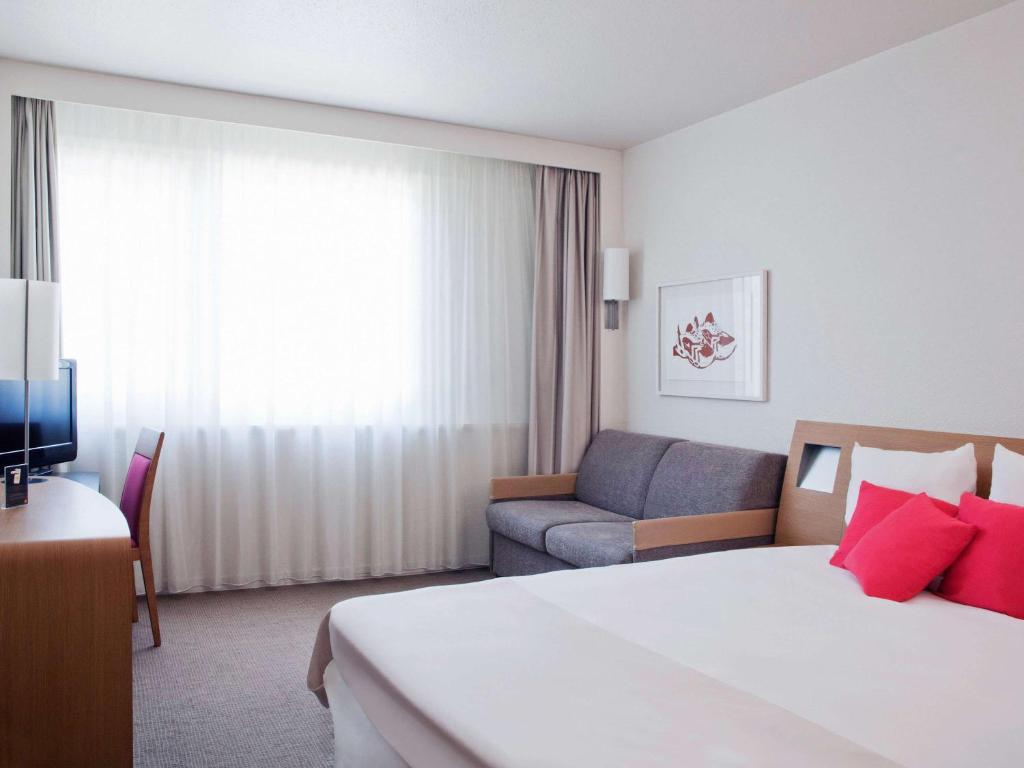 Кровать или кровати в номере Novotel Setubal