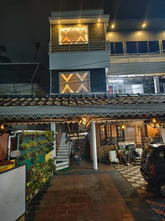a building at night with a car parked in front at Casa De Nazareth Homestay in Cochin