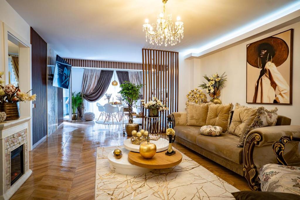 a living room with a couch and a table at Almi Aparthotel in Cluj-Napoca