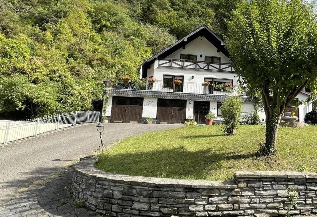 a house with a tree in front of it at Apartment Jobelius in Beilstein
