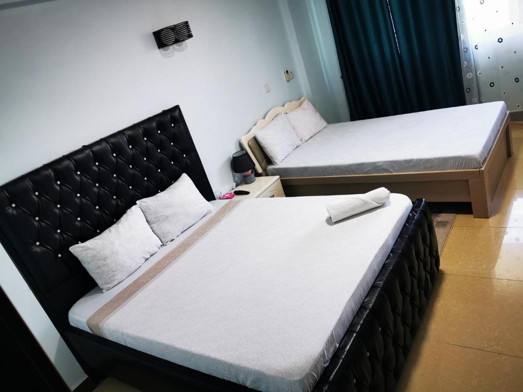 Cama o camas de una habitación en Skylar H & Apartment