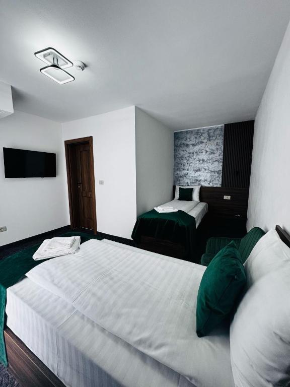 Postel nebo postele na pokoji v ubytování Hotel Popasul Regelui Transalpina